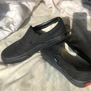 All black slip on vans